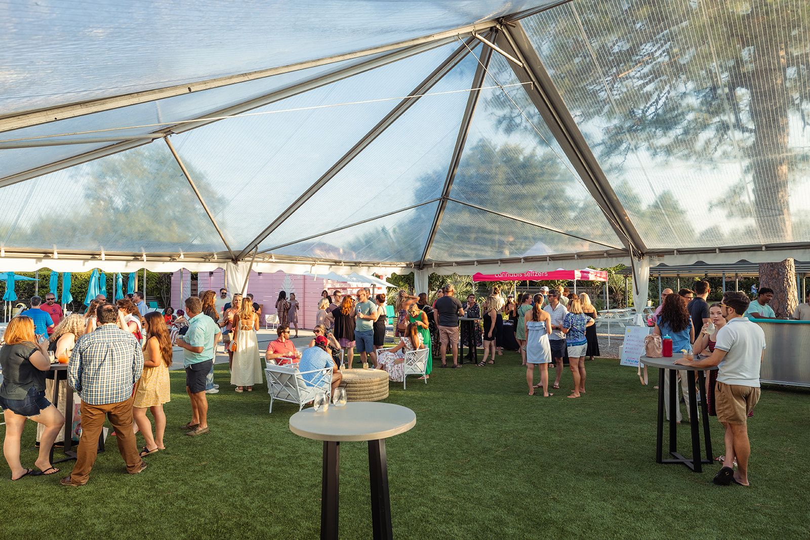 Clear-top tent over the event lawn during a cocktail reception
